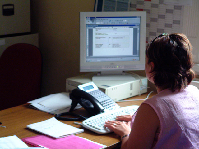 A woman using a desktop computer