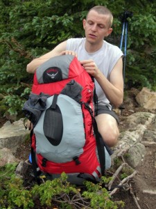 A man with an Osprey backpack