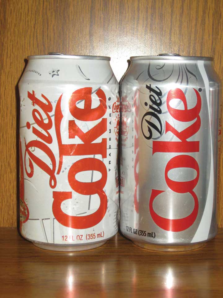 An old Diet Coke can next to a new one