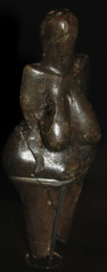 A small statuette of a female figure.
