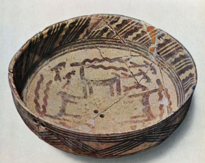 A ceramic bowl painted with simple designs.