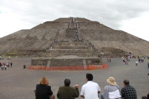 People sit looking at a pyramid