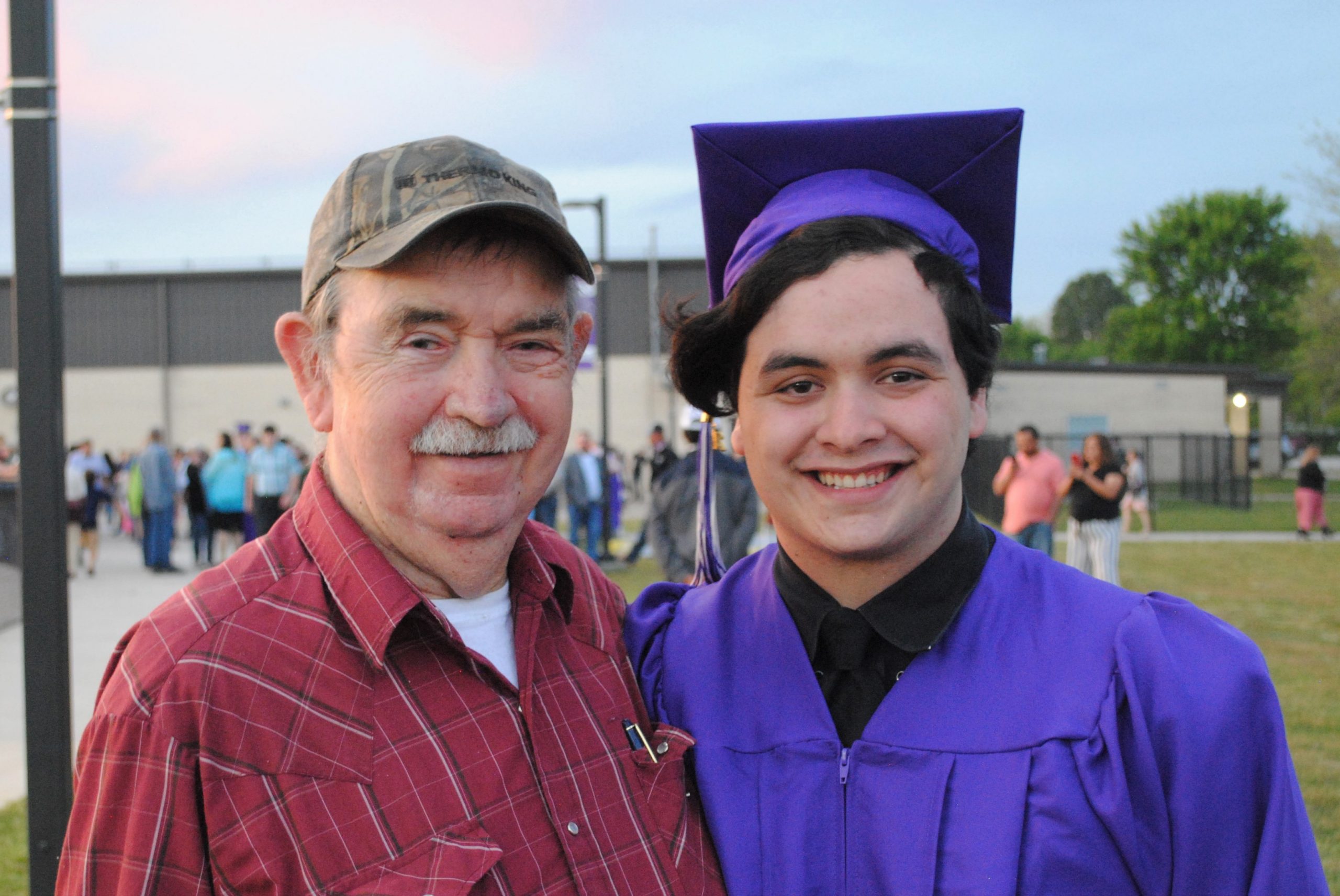 A picture of a graduate and his grandfather