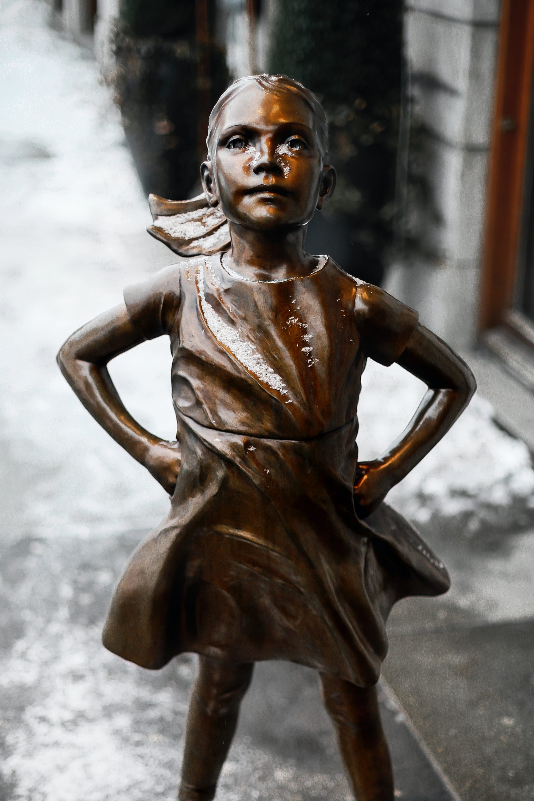 Bronze statue of girl with hands on her hips